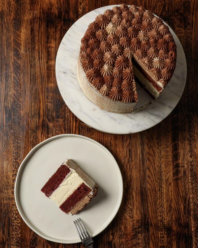 Mother’s Day is next Sunday, so don’t forget to treat her to something special! 
Our Red Velvet Cheesecake is two layers of red velvet cake with a layer of cheesecake inside, iced with cream cheese icing, and topped with a whipped milk chocolate ganache. Each cake serves 10-16 and is perfect for a luncheon or dinner. Preorders are open until Tuesday 5/7 and orders can be picked up on Saturday 5/11 from 8am-3pm at our shop. We will be closed on Mother’s Day 5/12.